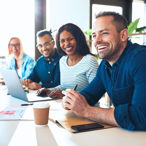 Colleagues laughing during meeting no street